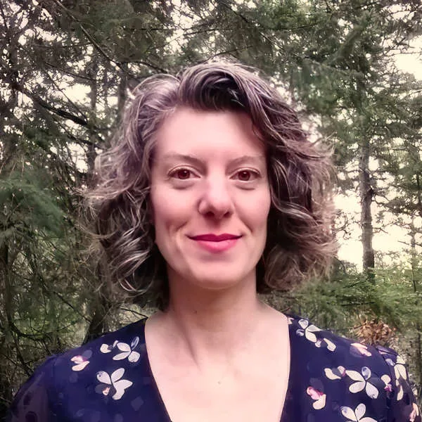 Portrait of Geneva Jacobs outdoors in front of trees.